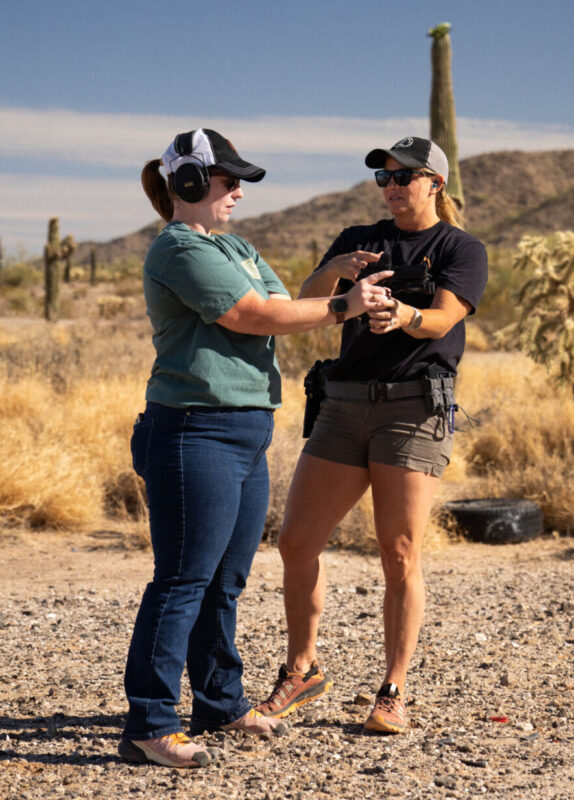 Two women on the range. One instructing the other.